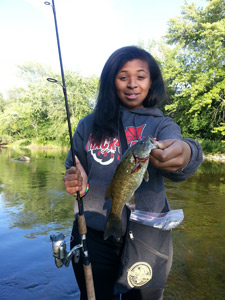 Hannah Robinson of Milwaukee hoists her first smallmouth like a pro while fishing with OWO writer John Lindeman