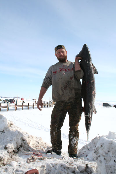 man holding sturgeon