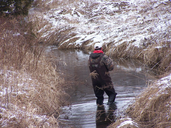 man standing in river