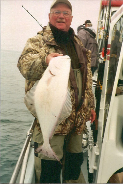 Mike Yurk with halibut on fishing boat