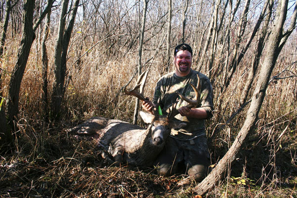 photo of Bob Mercier in woods with deer