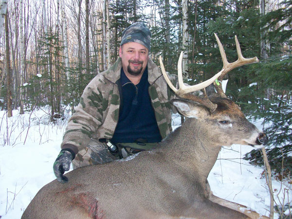 man in woods with deer