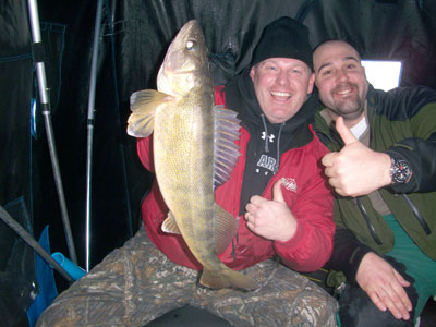 two men holding fish