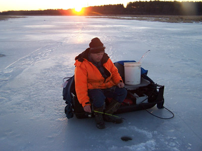 Ice fishing at sunset
