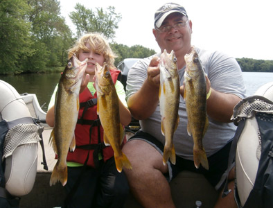 Nathaniel house and his dad Jamie with some of their catch of walleyes from the day