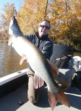 Ron Hall with ta nice fall musky he caught with Guide Phil Schweik while jigging