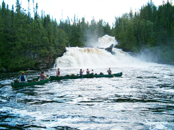 canoers near water fall